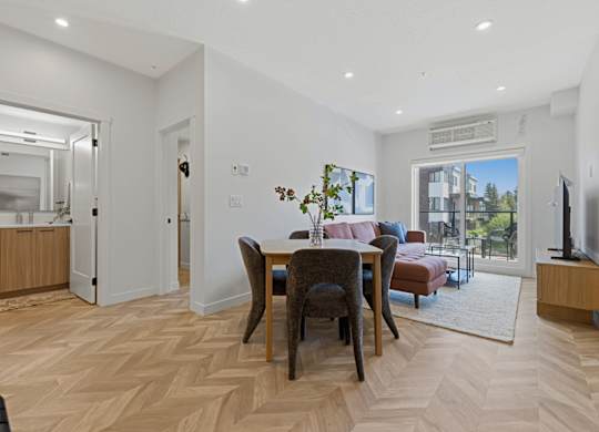 A living room with a dining table and chairs.