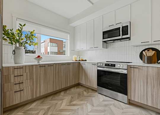 A kitchen with wooden cabinets and a black oven.