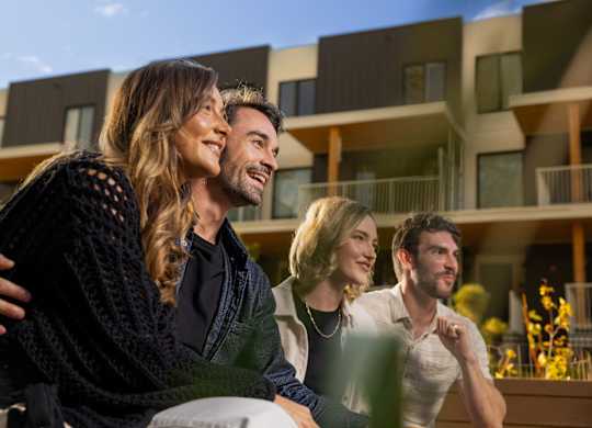 A group of people are standing in front of a building.