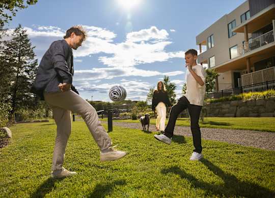 Two men playing frisbee in a sunny park.