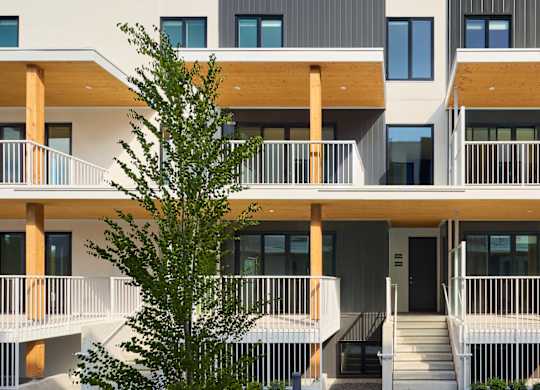 A modern building with a tree in front.