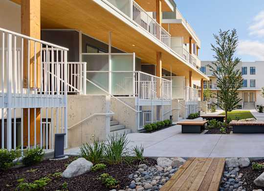 A modern apartment complex with balconies and a landscaped courtyard.