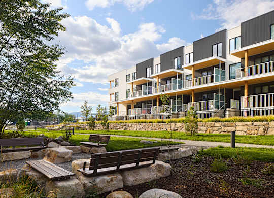 A modern building with a garden in front.
