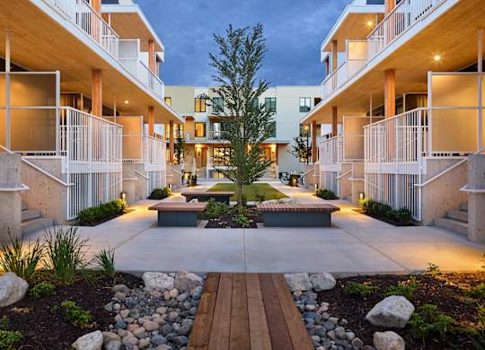 A modern apartment complex with a central courtyard and landscaping.