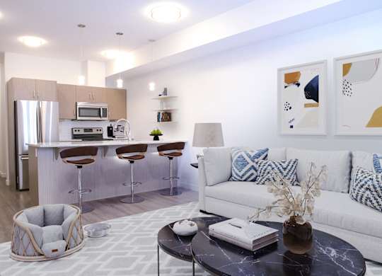 A modern living room with a white couch and a black coffee table.