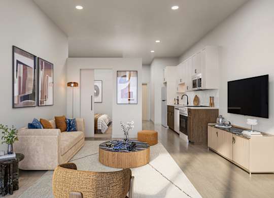 A modern living room with a sofa, coffee table, and television.