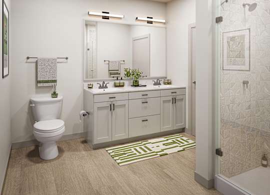 A white toilet sits in a bathroom next to a sink and mirror.