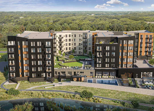 A modern apartment complex with a large courtyard and a swimming pool.