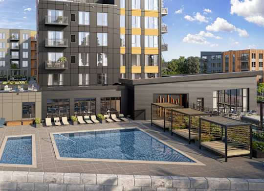 A modern apartment complex with a pool in the foreground.