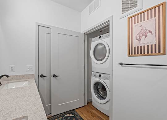 A laundry room with a washer and dryer in it.