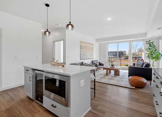 A modern kitchen with a large island and stainless steel appliances.