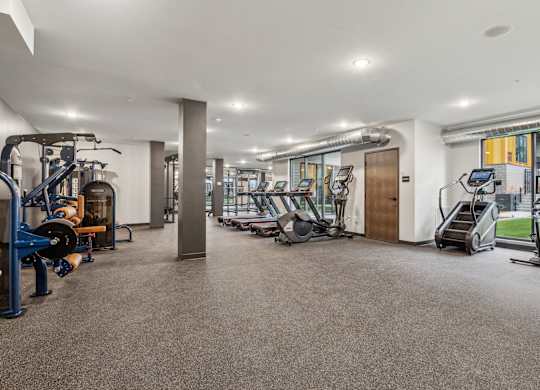 A spacious gym with various exercise equipment.