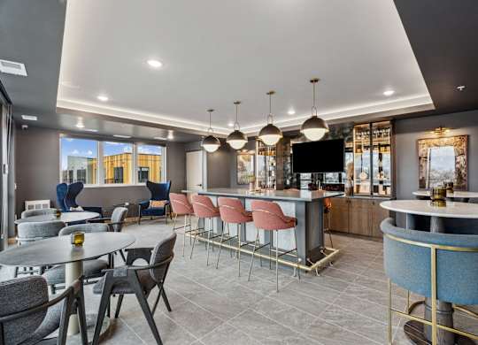 A modern dining area with a bar and chairs.