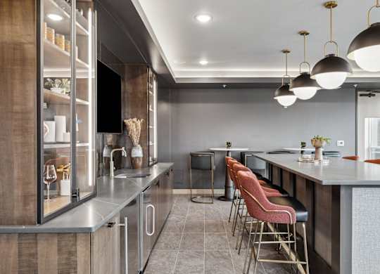 A modern kitchen with a bar area and seating.