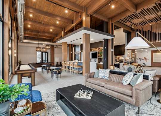 A living room with a brown couch and a black coffee table.