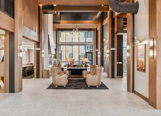 A spacious lobby with a large table and chairs.