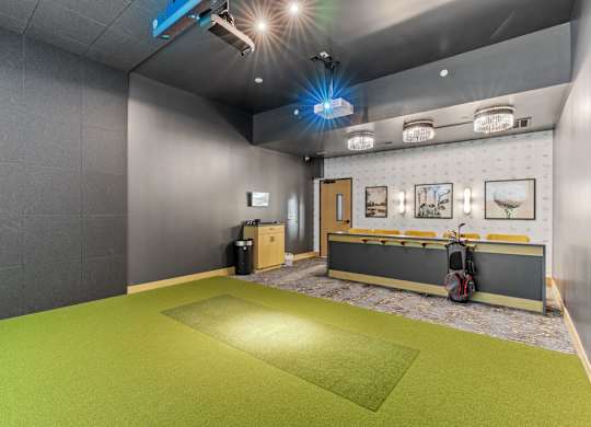 A room with a green floor and grey walls.