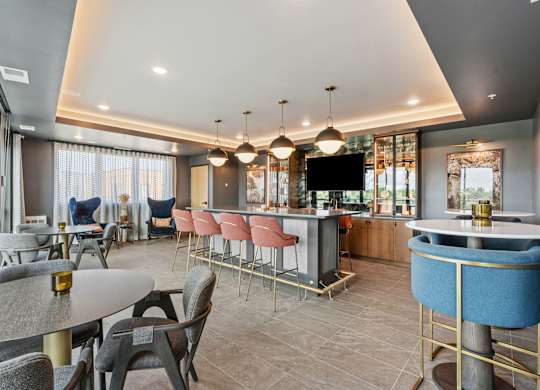 A modern dining area with a bar and a television.