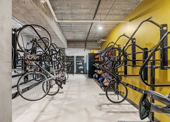 A bike rack with many bicycles parked in it.
