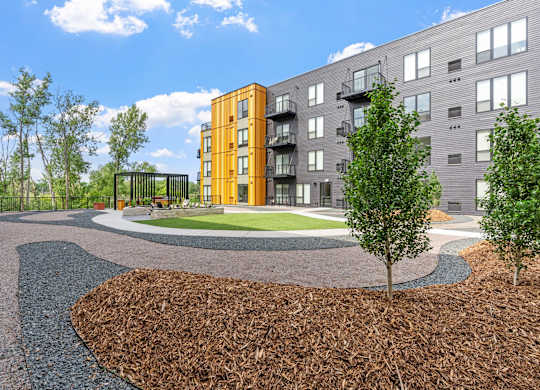 A modern apartment complex with a landscaped courtyard.