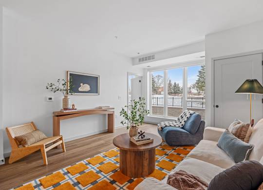 A living room with a white couch and a wooden coffee table.