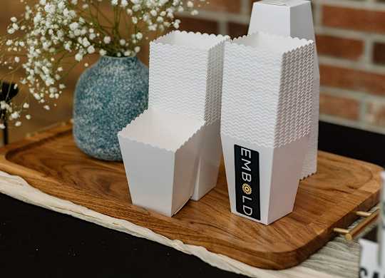 A white model of a building with the text