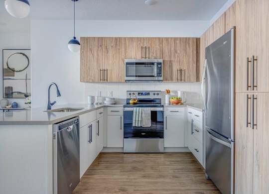 A modern kitchen with stainless steel appliances and wooden cabinets.