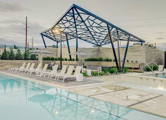 A pool with a blue and white structure above it.