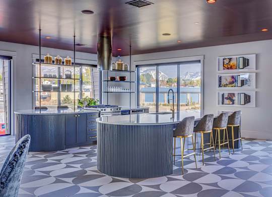 A modern bar with a curved counter and a row of stools.