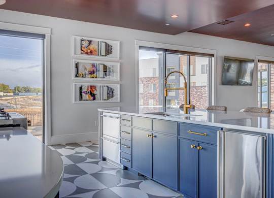 A kitchen with blue cabinets and a white counter.