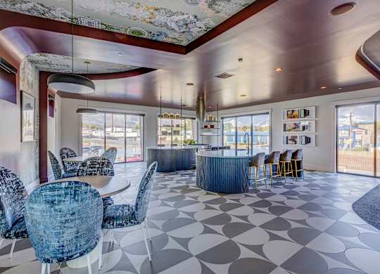 A modern dining room with a large table and chairs.