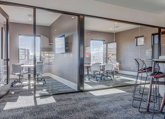 A conference room with glass walls and a carpeted floor.