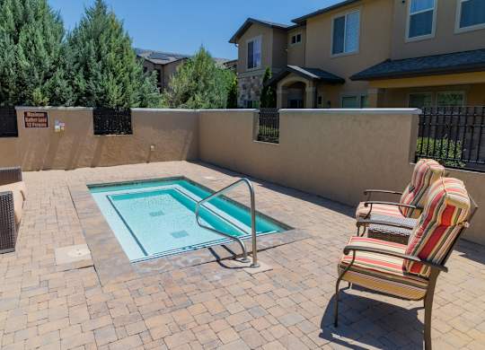 Four Seasons Logan Apartments and Townhomes Seating by Hot Tub