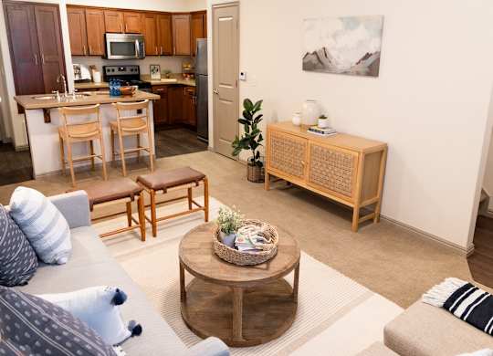 Four Seasons Logan Apartments and Townhomes Living Room with View of Kitchen