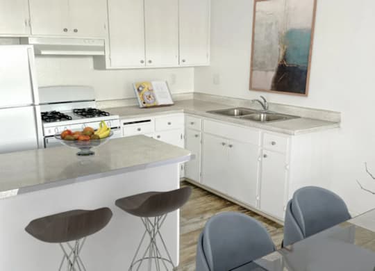 A kitchen with white cabinets and a white fridge.