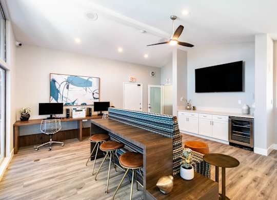 A modern home office with a bar and a television at Chaparral Apartments, California