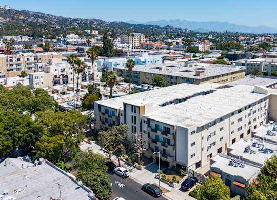 A large white building with a parking lot in front of it.