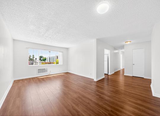 A room with wooden floors and white walls.
