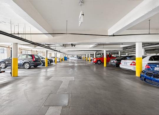 A parking garage with cars parked in yellow and blue columns.