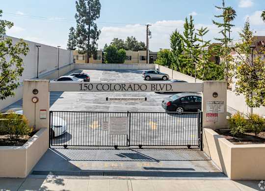 The entrance to a building with a sign that reads at Oak Park Apartments, Monrovia, 91016