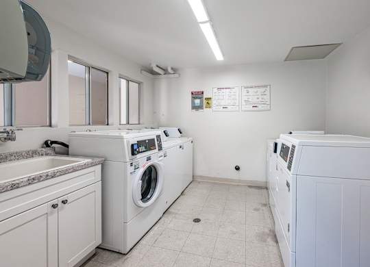 A laundry room with a washer and dryer at Oak Park Apartments, Monrovia, 91016