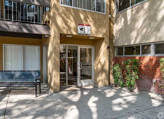 A building with a bench in front of it at Oak Park Apartments, Monrovia, 91016