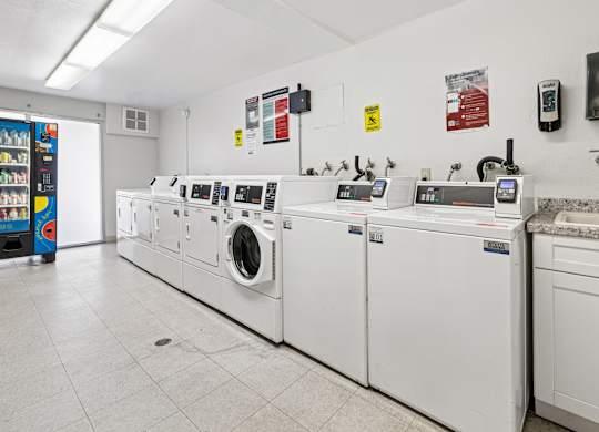 A row of washing machines in a laundromat.