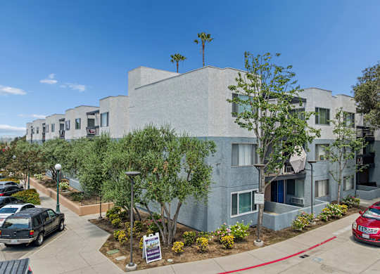 A modern building with a parking lot in front.
