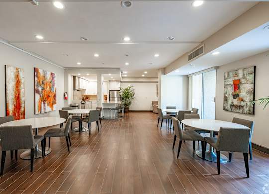 A dining room with a long table and chairs at Oak Park Apartments, Monrovia, 91016