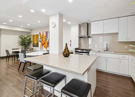 A kitchen with a bar area and a dining table.