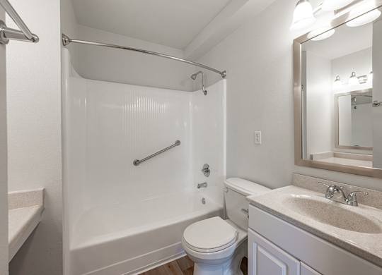 A white bathroom with a toilet, sink, and shower at Oak Park Apartments, Monrovia, 91016