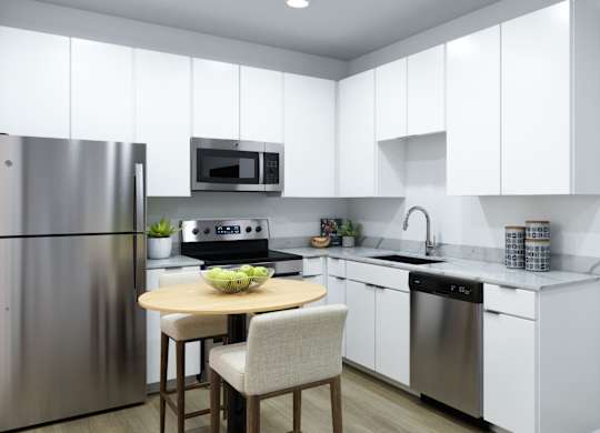 A modern kitchen with a table and chairs.