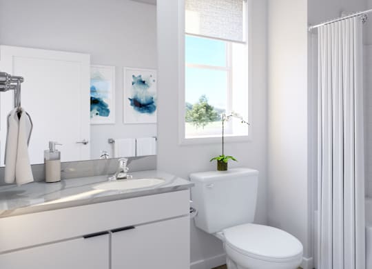 A white toilet sits next to a white sink in a bathroom.