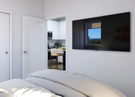 A bedroom with a bed, two doors, and a window.